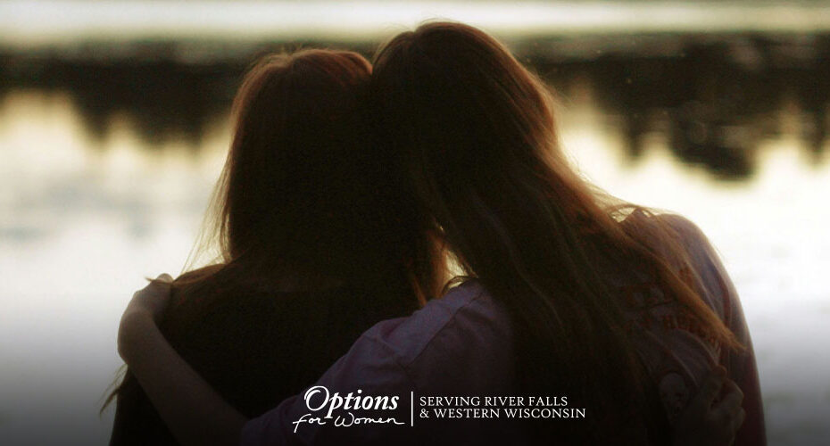 unexpected pregnancy support shown by friends sitting together, unplanned pregnancy support