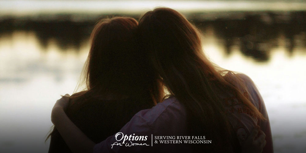 unexpected pregnancy support shown by friends sitting together, unplanned pregnancy support